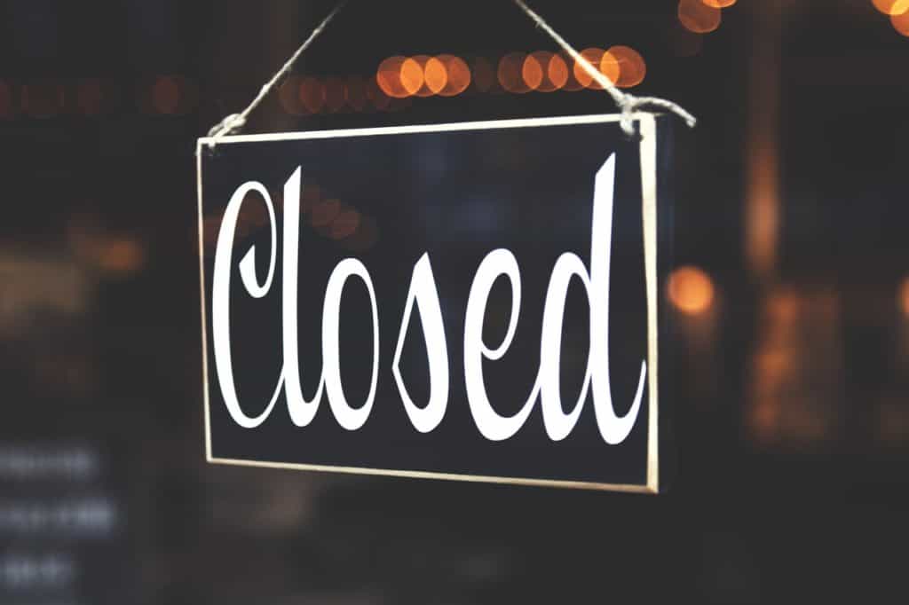 Closed sign with fairy lights in the background