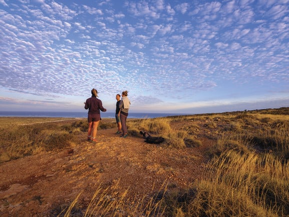 Three people standing on a hill in Sal Salis Ningaloo Reef near Exmouth