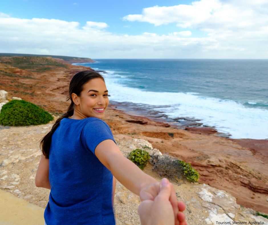 Girlfriend holding partners hand at Red Bluff Lookout at Kalbarri National Park