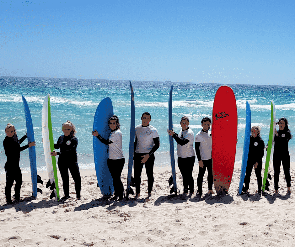 Perth International College of English students holding surfboards at Scarborough Beach, Perth.